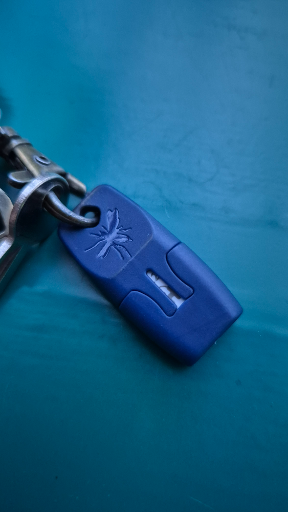 Spider-Man Swinging Over Blue Logo Keychain